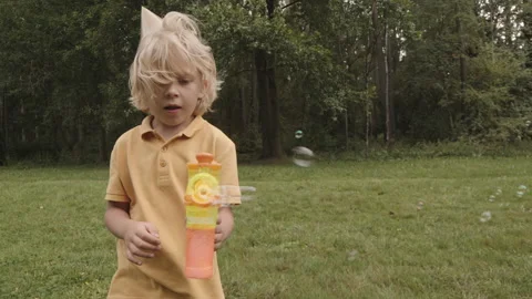 Boy Playing with Soap Bubble Maker Stock Footage 160338152