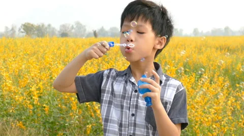 Boy playing soap bubbles Stock Footage 62354121