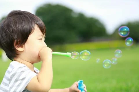 Boy playing with soap Fotos Stock
