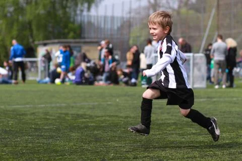 Boy playing soccer Stock Photos