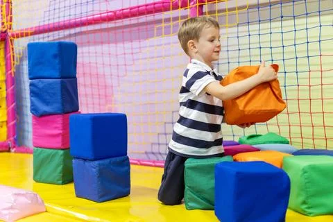 Boy playing with soft foam blocks Stock Photos