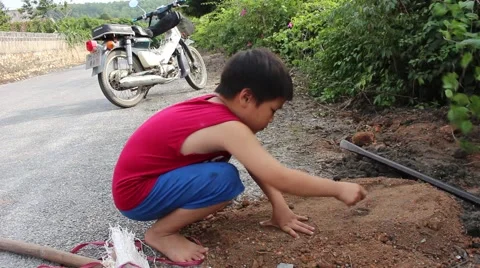 Boy playing in soil dust Stock Footage 45919439