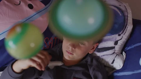 Boy playing with the space shuttle toy in his bedroom with planets of all h.. Stock Footage 264282891