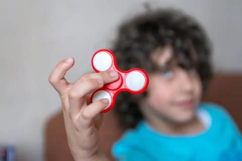 Boy playing with spiner Stock Photos