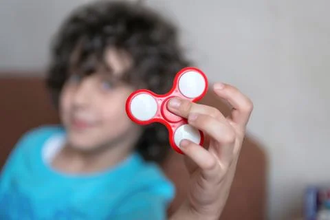 Boy playing with spiner Stock Photos