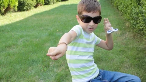 Boy playing with spinner Stock Footage 80446631
