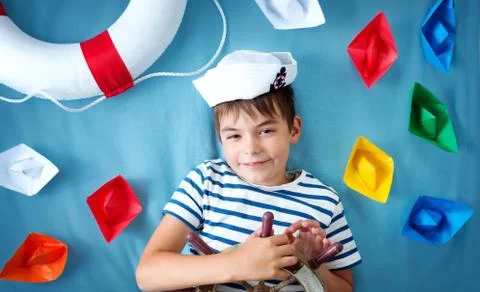 Boy playing with steering wheel Stock Photos