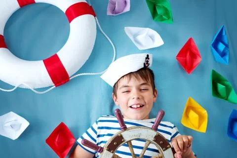 Boy playing with steering wheel Stock Photos
