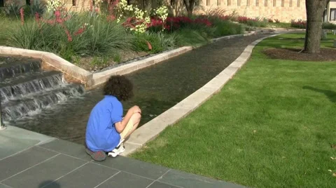 Boy Playing In Stream Stock Footage 1692866