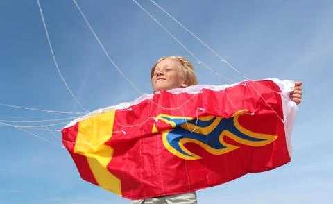 Boy is playing with stuntkite Stock Photos