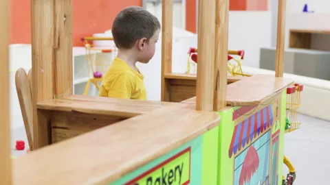 Boy playing in supermarket. Wooden toy counter. Stock Footage 264802453