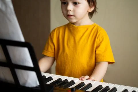 A boy playing the synthesizer Stock Photos