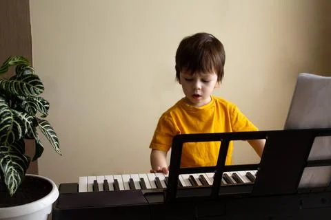 A boy playing the synthesizer Stock Photos