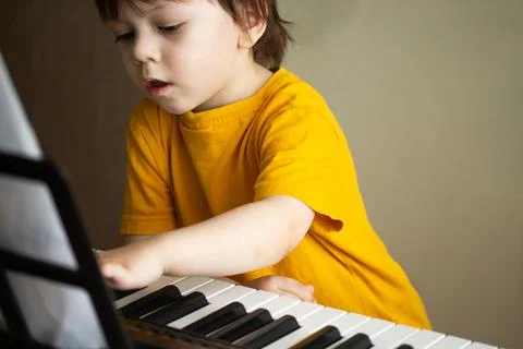 A boy playing the synthesizer Stock Photos
