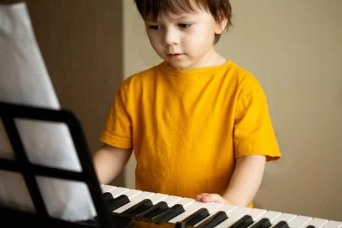 A boy playing the synthesizer Stock Photos