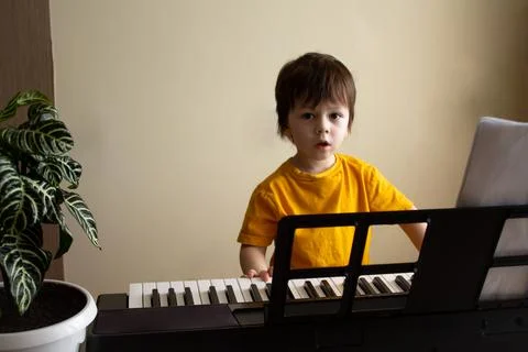 A boy playing the synthesizer Stock Photos
