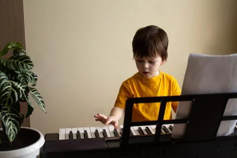 A boy playing the synthesizer Stock Photos