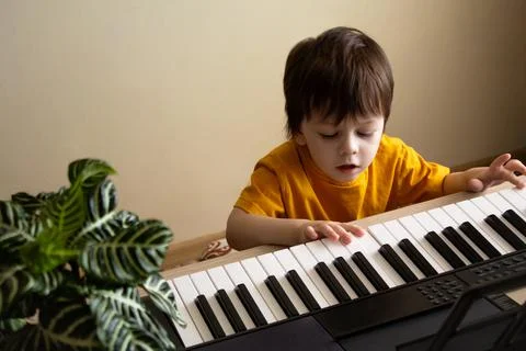 A boy playing the synthesizer Stock Photos
