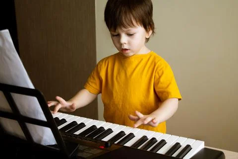 A boy playing the synthesizer Stock Photos