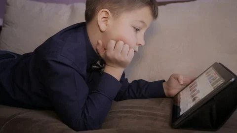 Boy playing on a tablet.Full hd video Video stock 71739386