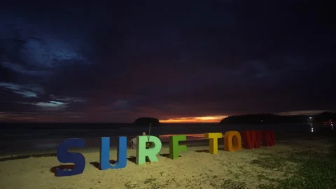 A boy playing with the text on the beach at twilight. Stock Footage 157905848