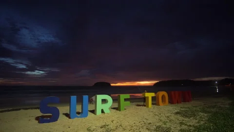 A boy playing with the text on the beach at twilight. Stock Footage 157906890
