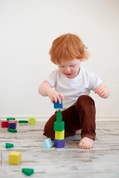 Boy playing with toy cubes Stock Photos