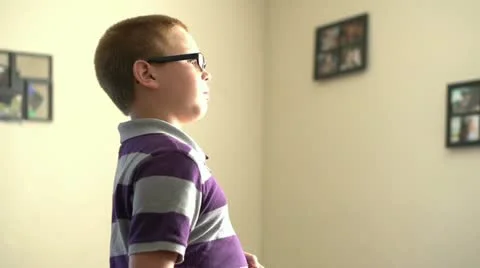 Boy playing with toy football in living room Stock Footage