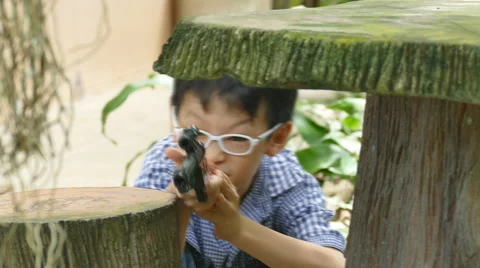 Boy playing with toy gun Stock Footage 55809155