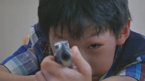 Boy playing with toy gun Stock Footage 56026153