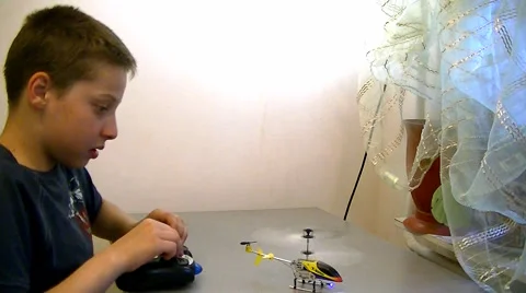 Boy playing with toy helicopter Stock Footage 63228210