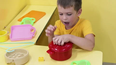 Boy playing with toy kitchen. Stock Footage 264801469