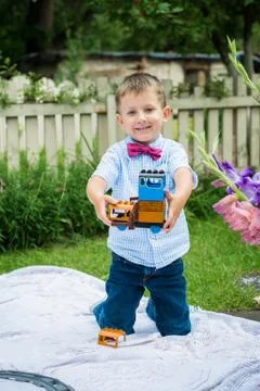 Boy playing with toy train Stock Photos