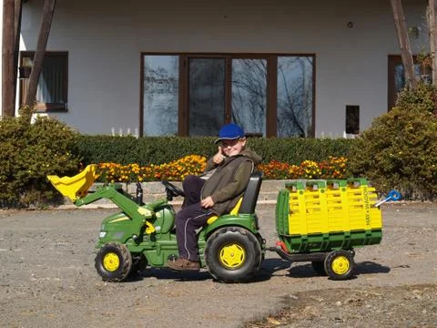 Boy playing with tractor Stock Photos