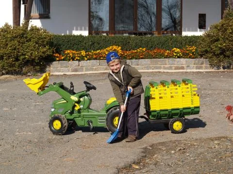 Boy playing with tractor Stock Photos