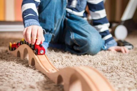 Boy playing with train Photos