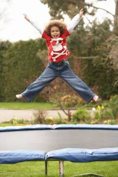 Boy playing on trampoline Stock Photos