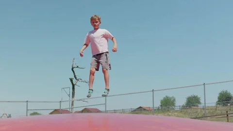 A Boy is Playing on a Trampoline Slow Motion 스톡 동영상 345710870