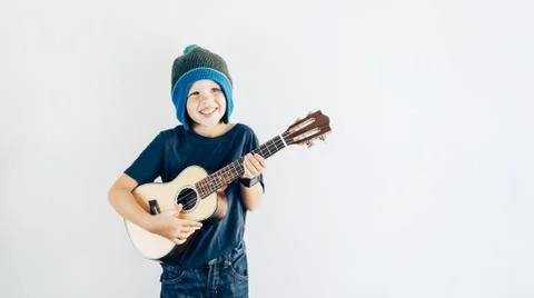 Boy playing ukulele Foto stock