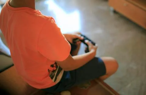 Boy playing video game console Stock Photos
