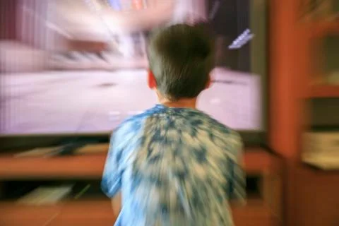 Boy playing video game console Stock Photos