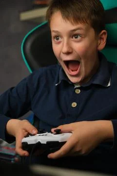 The boy is playing a video game console Stock-Fotos