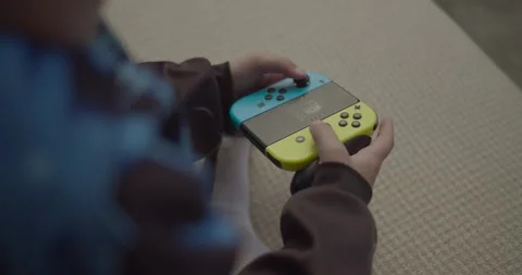 Boy playing with video game controller Stock-Footage 253742404