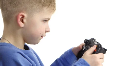 Boy playing video game with games console. White background, closeup Vidéo 75921158