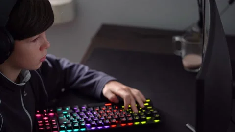 Boy is playing video game on his computer, looking at monitor Stock Footage 225051211