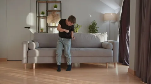 Boy Playing Video Game Indoors. Focused child tablet digital fun cozy home Stock Footage 335478043