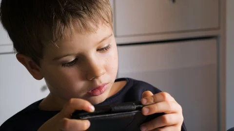 Boy playing video game on mobile phone. Young hacker. Cyber security background Stock Footage 123742912