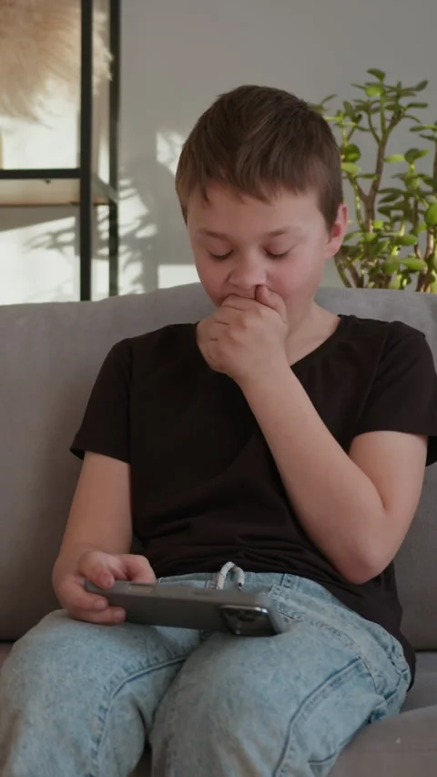 Boy Playing Video Game on Phone Stock Footage 335483963