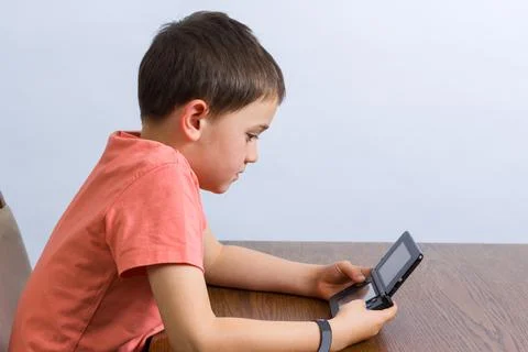 Boy playing video game Stock Photos