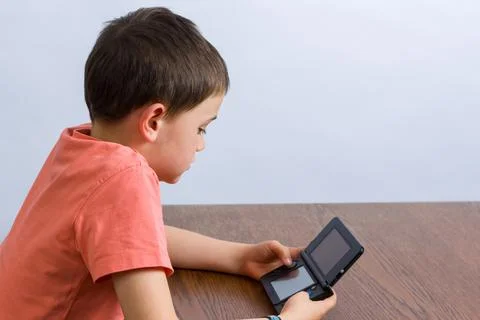 Boy playing video game Stock Photos